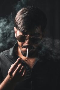 selective focus photography of man smoking cigarette